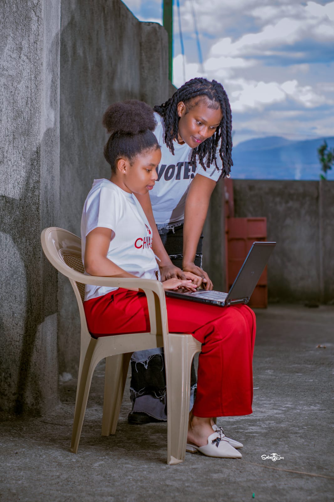 A CurioCity learner working on a laptop with a mentor